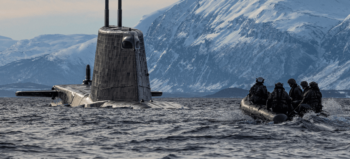 People approaching a submarine in a boat