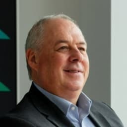 Head shot of Martin Porter, wearing a suit and smiling