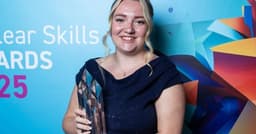 Keely Salter holds a Nuclear Skills award and smiles at the camera